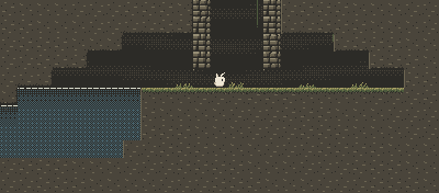 A dark cave under the fen, with a pool of still water and reeds growing in the gloom.